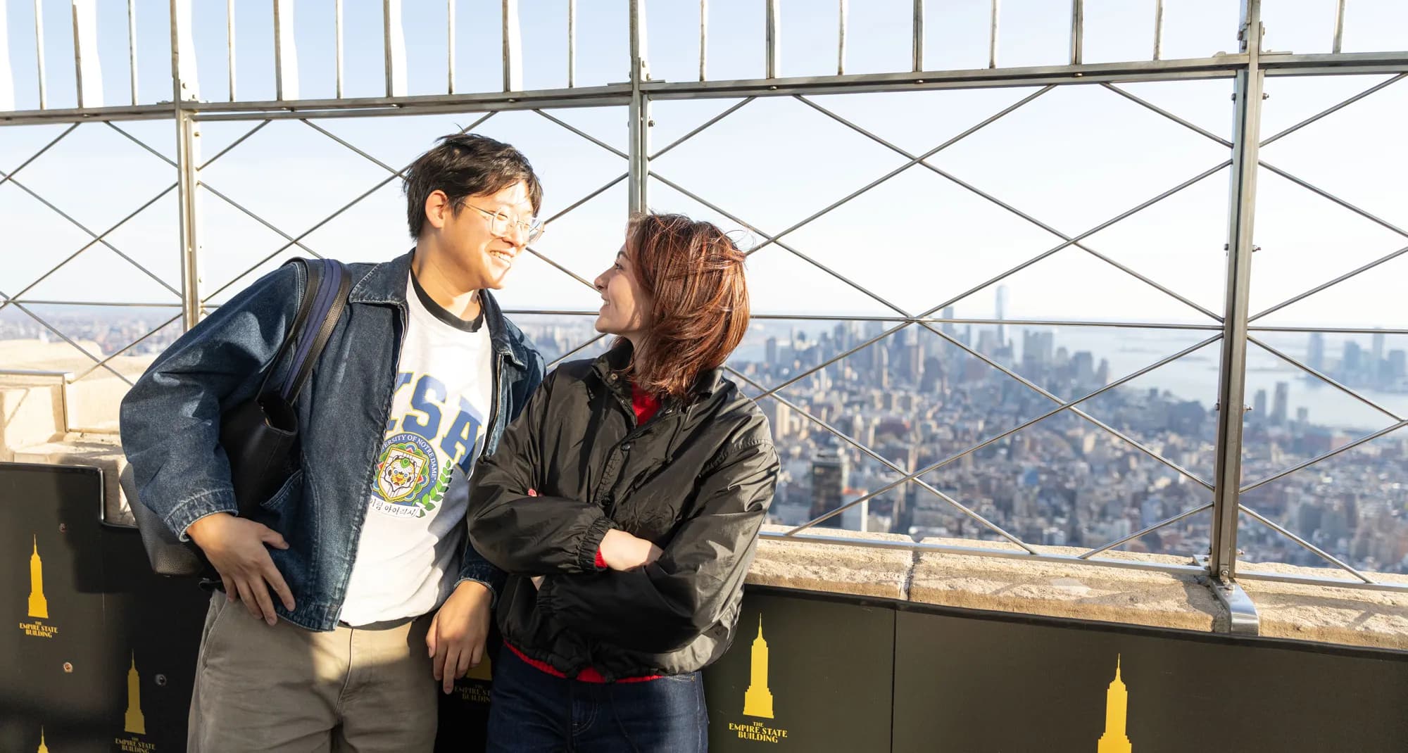 Couple looking at each other with the NYC view behind them